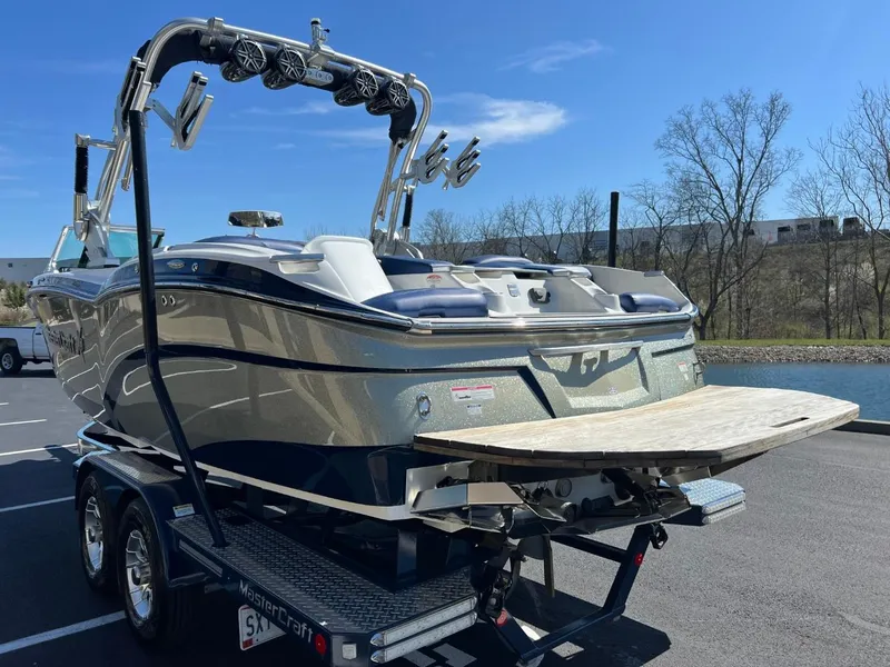 Slide: The Image of 2016 MasterCraft X23 boat on trailer, rear view, sunny day. - 5