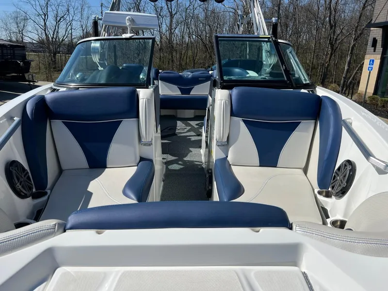 Slide: The Image of 2016 MasterCraft X23 boat interior with blue and white seating. - 6