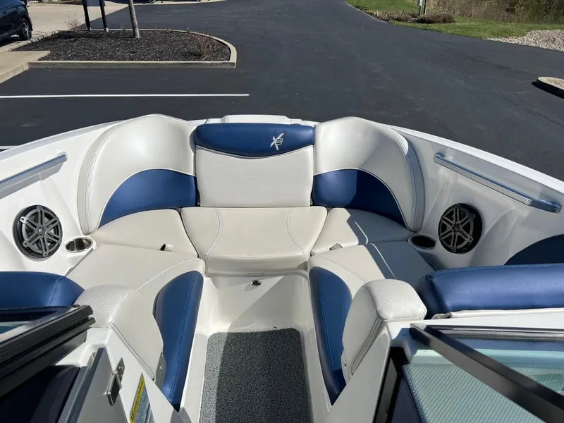 Slide: The Image of 2016 MasterCraft X23 boat interior with white and blue seating. - 7