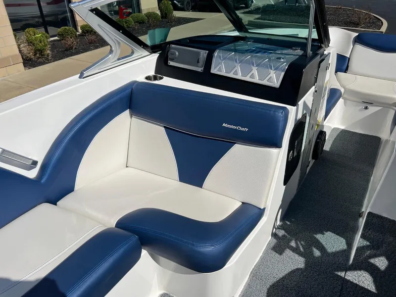 Slide: The Image of 2016 MasterCraft X23 boat interior with blue and white seating. - 9