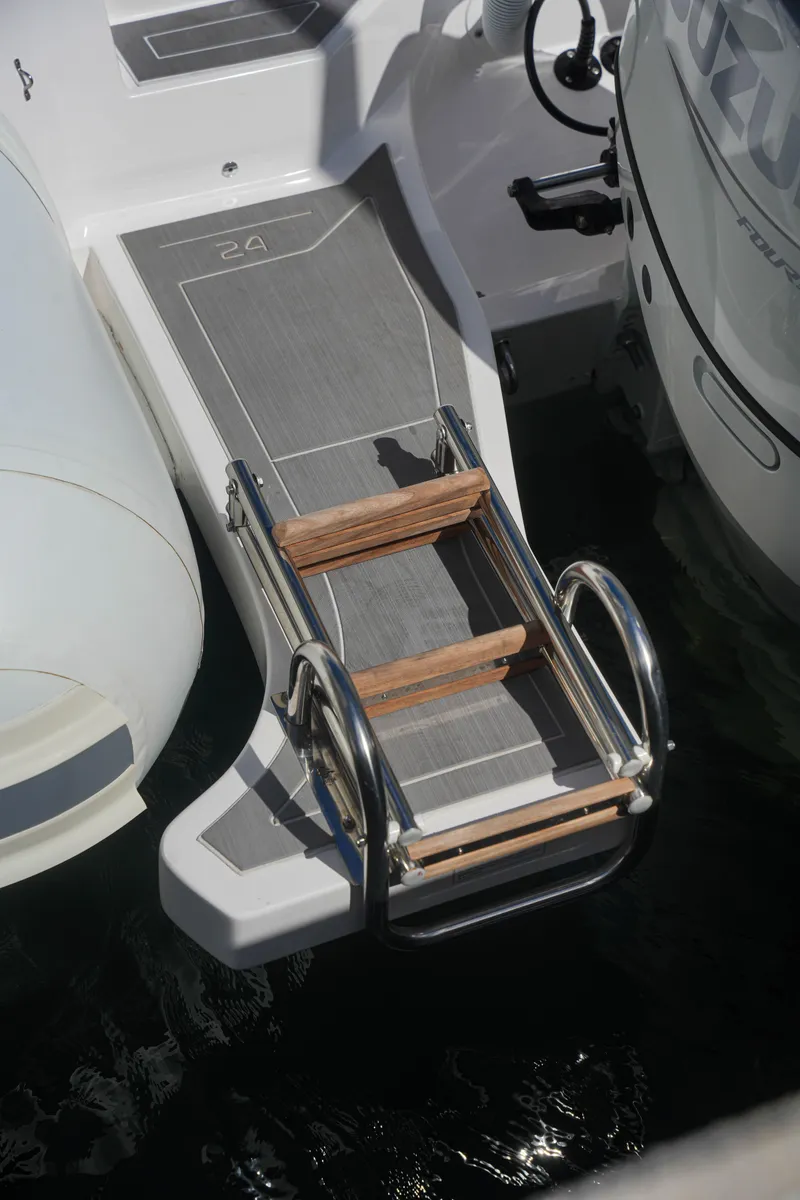 Slide: The Image of 2025 Sea Prop COMFORT 24 boat with swim ladder and Suzuki outboard motor. - 21