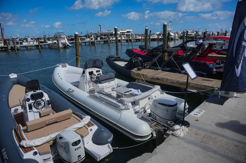 Slide: The Image of 2025 Sea Prop COMFORT 24 boats docked at marina under blue sky. - 4