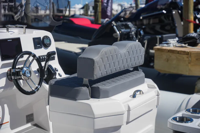 Slide: The Image of 2025 Sea Prop COMFORT 24 boat interior with modern steering console and cushioned seating. - 7