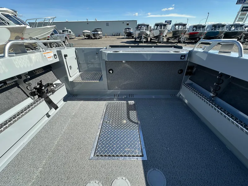 Slide: The Image of 2024 Hewescraft 190 Searunner HT FC boat interior, spacious deck, and storage compartments. - 5