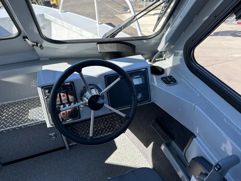 Slide: The Image of 2024 Hewescraft 190 Searunner HT FC boat interior, featuring steering wheel and control panel. - 7