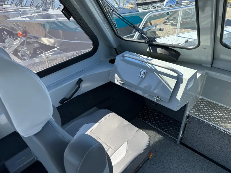 Slide: The Image of Interior of 2024 Hewescraft 190 Searunner HT FC, featuring seating and storage. - 8