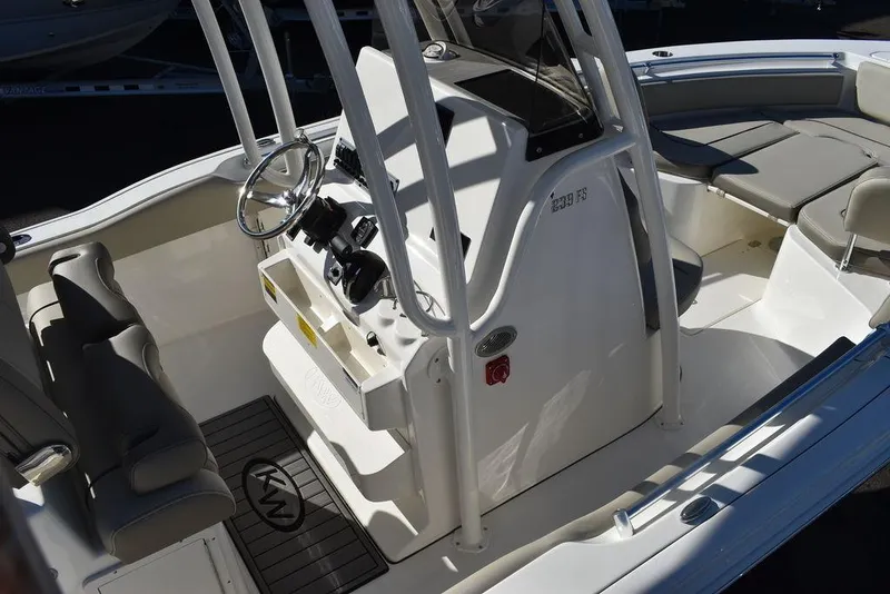 Slide: The Image of 2024 Key West 239 FS boat interior with steering console and seating. - 14