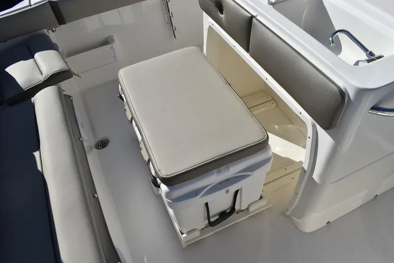 Slide: The Image of 2024 Key West 239 FS boat interior with cushioned cooler seat. - 23