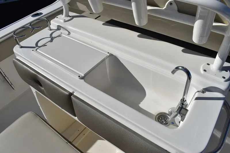 Slide: The Image of 2024 Key West 239 FS boat sink and storage area with cup holders. - 24