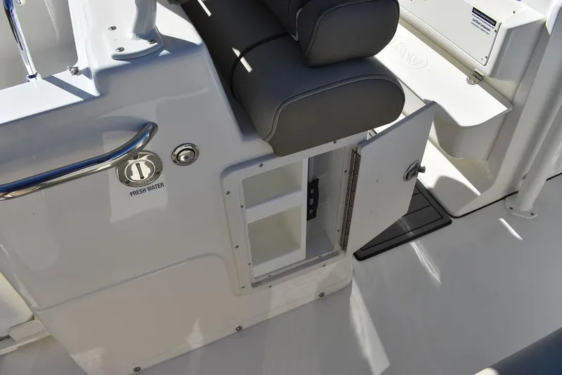 Slide: The Image of 2024 Key West 239 FS boat interior storage compartment with open door. - 26