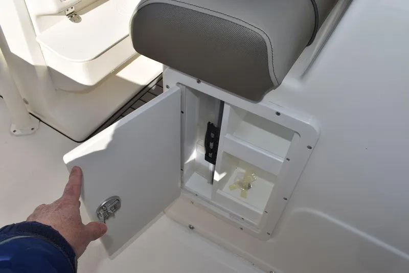 Slide: The Image of 2024 Key West 239 FS boat storage compartment with open door. - 27