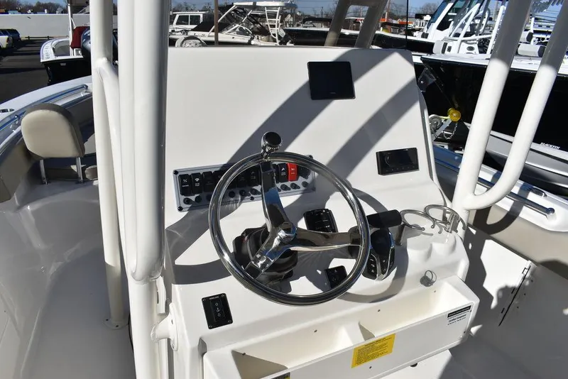 Slide: The Image of 2024 Key West 239 FS boat helm with steering wheel and controls. - 30