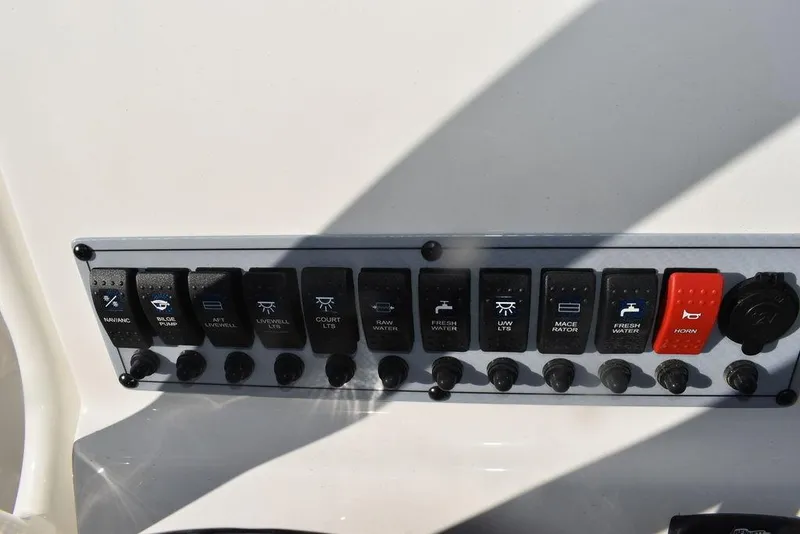 Slide: The Image of Control panel of 2024 Key West 239 FS boat with various switches and buttons. - 32