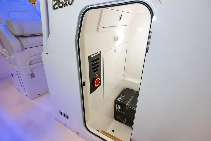 Slide: The Image of 2025 Regulator 26XO boat interior storage compartment with control panel and seating. - 15