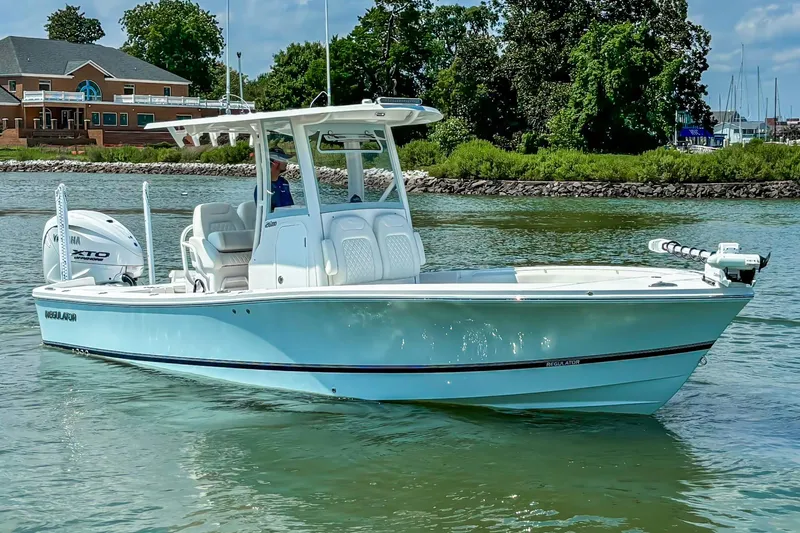 The Image of 2025 Regulator 26XO boat on calm water, featuring sleek design and Yamaha engine. - 16