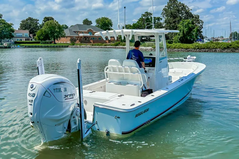 Slide: The Image of 2025 Regulator 26XO boat with Yamaha 450 V8 engine on calm water. - 18