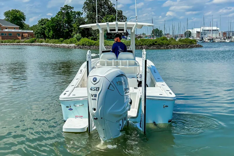 Slide: The Image of 2025 Regulator 26XO boat with Yamaha 450 V8 engine on calm water. - 19