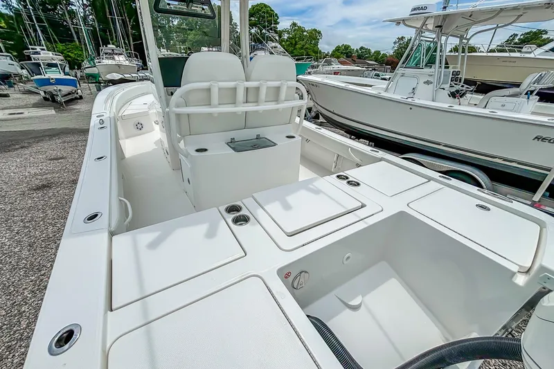 Slide: The Image of 2025 Regulator 26XO boat interior with seating and storage compartments. - 23