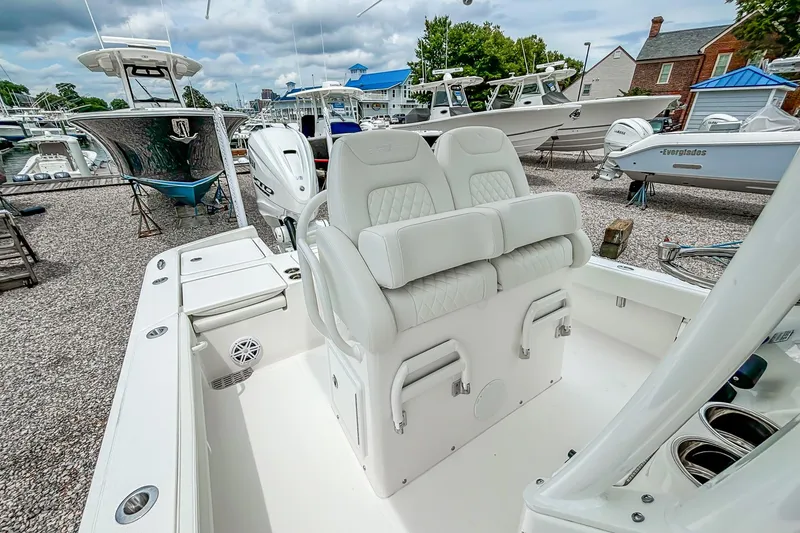 Slide: The Image of 2025 Regulator 26XO boat interior with dual seats and modern design at a marina. - 25