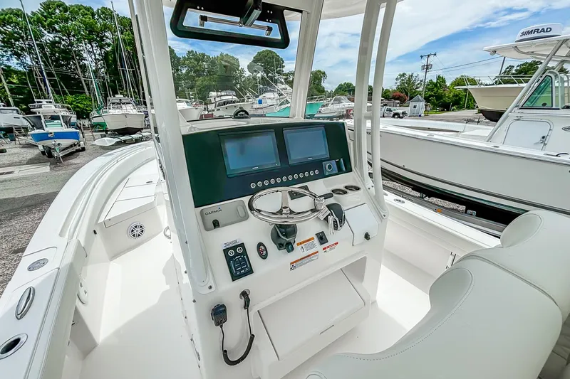 Slide: The Image of 2025 Regulator 26XO boat cockpit with advanced navigation system and steering wheel. - 26