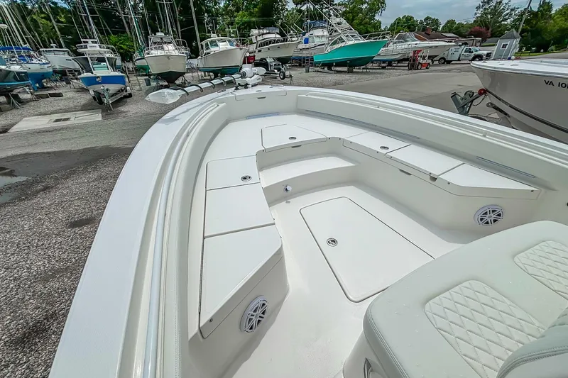 Slide: The Image of 2025 Regulator 26XO boat interior with spacious seating and storage, docked among other boats. - 29