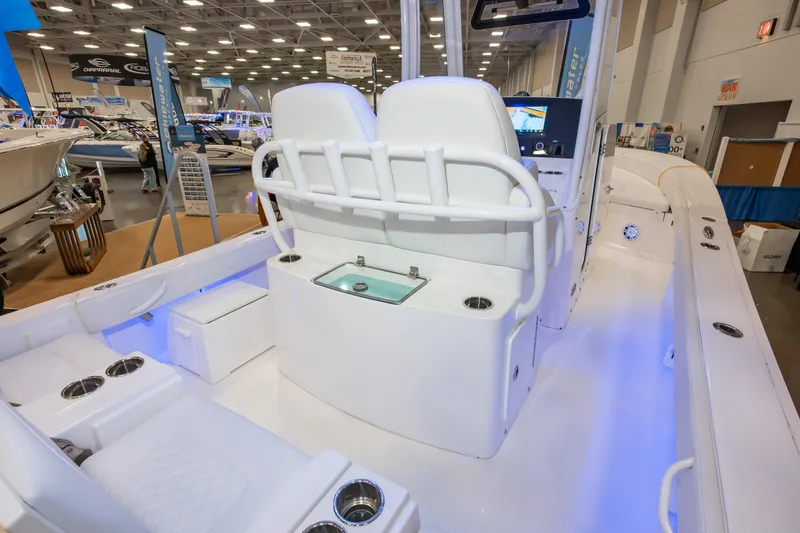 Slide: The Image of 2025 Regulator 26XO boat interior at a boat show, featuring seating and control panel. - 3