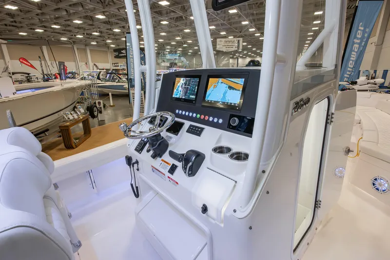 Slide: The Image of 2025 Regulator 26XO boat console with advanced navigation displays at a boat show. - 8