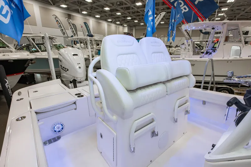 Slide: The Image of 2025 Regulator 26XO boat interior with white seating and modern design at a boat show. - 9