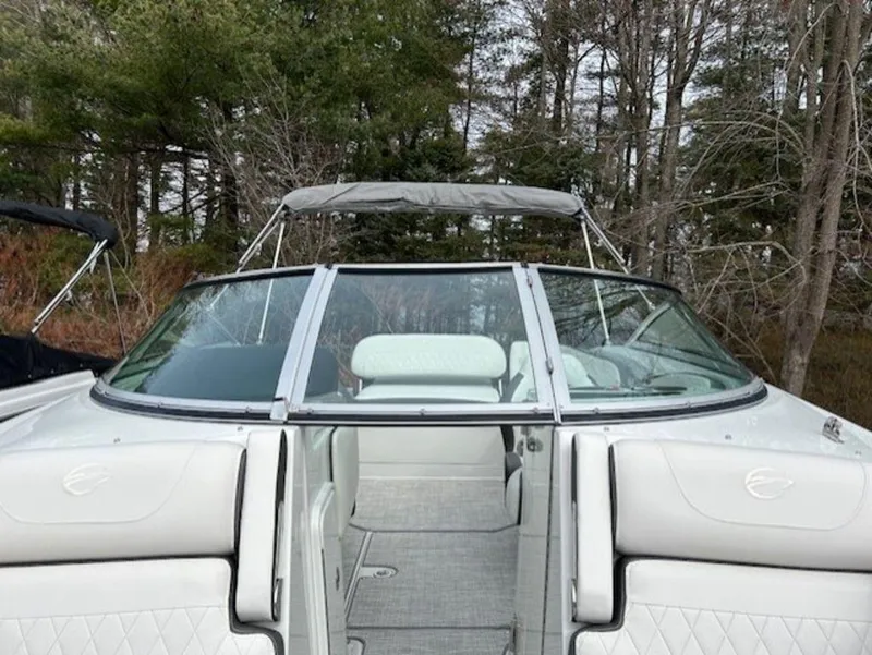 Slide: The Image of 2024 Crownline E Series E235 boat with open bow and white interior. - 10