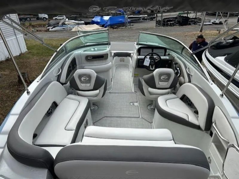 Slide: The Image of 2024 Crownline E Series E235 boat interior with spacious seating and modern dashboard. - 4