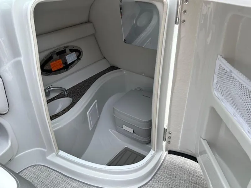 Slide: The Image of 2024 Crownline E Series E235 boat interior bathroom with sink and toilet. - 9