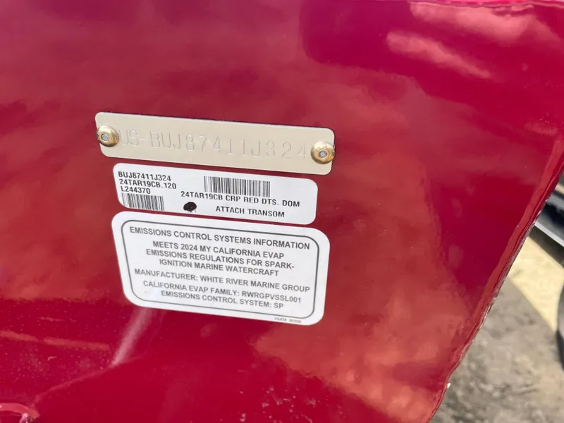 Slide: The Image of 2024 Tracker Targa V-19 Combo emissions control information and serial number plate. - 3