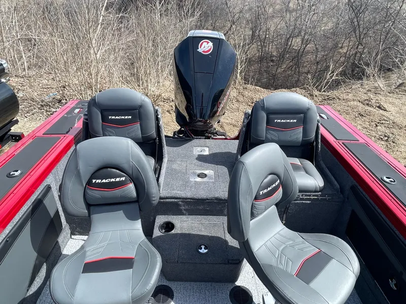 Slide: The Image of 2024 Tracker Targa V-19 Combo boat interior with four seats and outboard motor. - 7