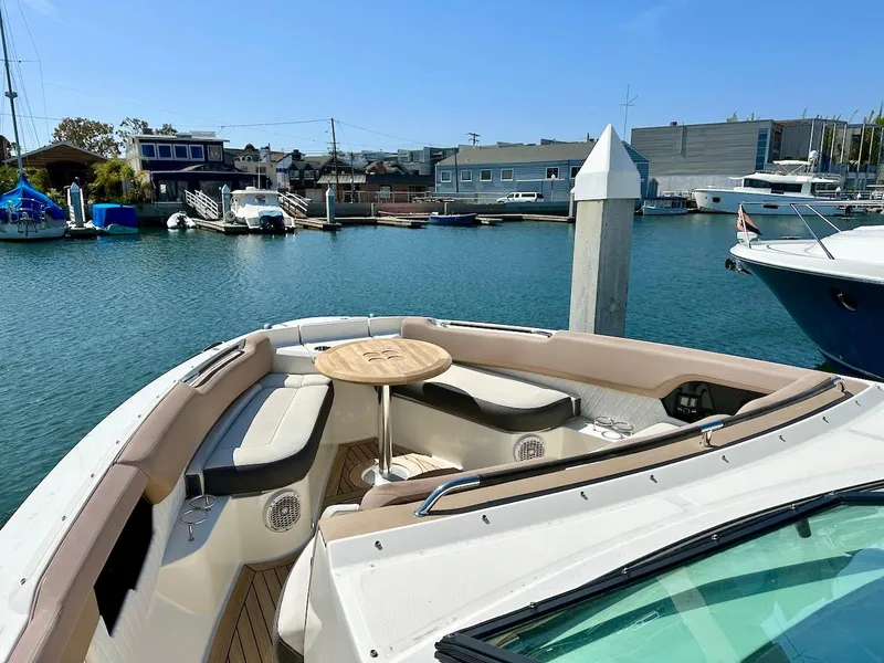 Slide: The Image of 2018 Sea Ray SLX 400 boat docked at a marina with seating area. - 18