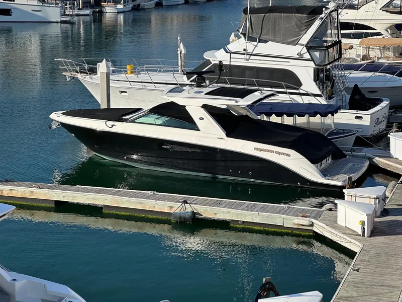 Slide: The Image of 2018 Sea Ray SLX 400 boat docked at a marina. - 29