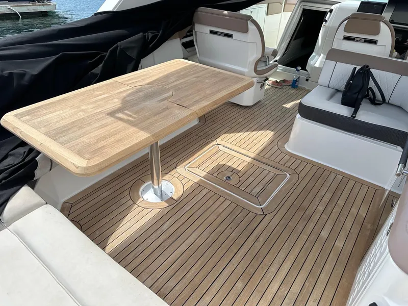 Slide: The Image of 2018 Sea Ray SLX 400 boat interior with wooden deck and seating area. - 3