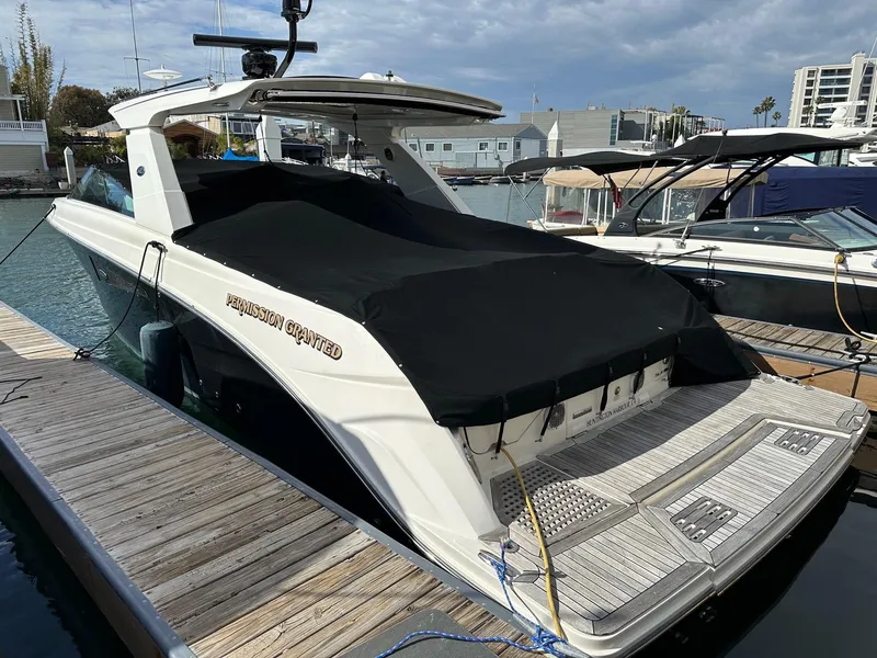 Slide: The Image of 2018 Sea Ray SLX 400 docked at marina with black cover. - 31