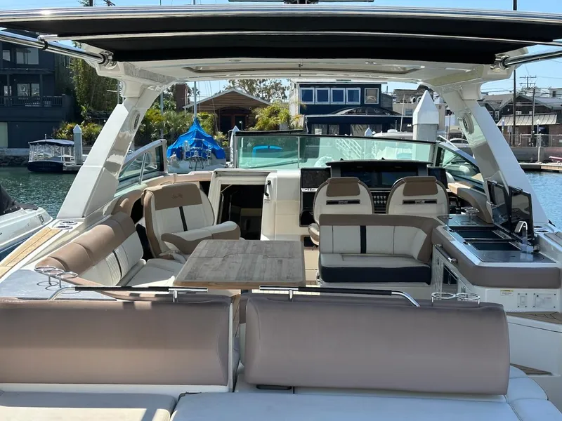 Slide: The Image of 2018 Sea Ray SLX 400 boat interior with seating and table. - 7