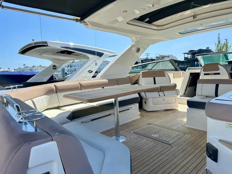 Slide: The Image of 2018 Sea Ray SLX 400 yacht interior with luxurious seating and wooden flooring. - 8