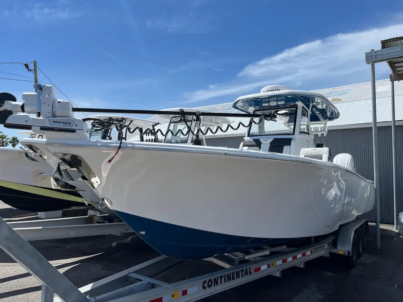 The Image of 2025 Tidewater 3100 Carolina Bay boat on a trailer under a clear blue sky. - 0