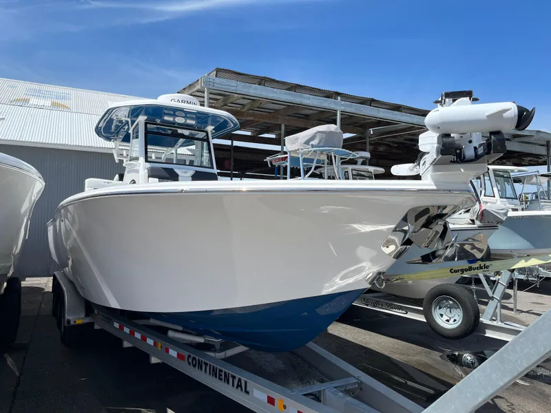 Slide: The Image of 2025 Tidewater 3100 Carolina Bay boat on a trailer in a marina. - 1