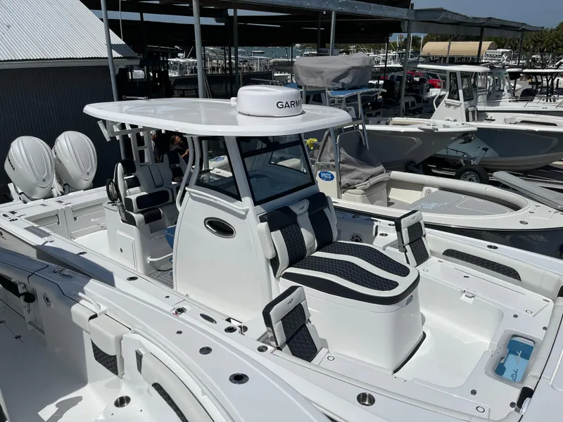 Slide: The Image of 2025 Tidewater 3100 Carolina Bay boat with Garmin electronics at a marina. - 11