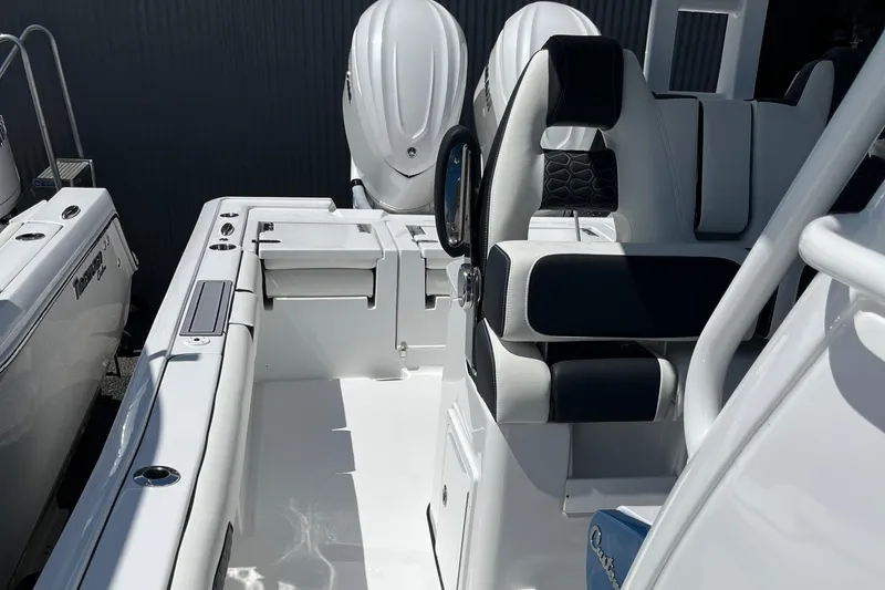 Slide: The Image of 2025 Tidewater 3100 Carolina Bay boat interior with dual outboard engines. - 14