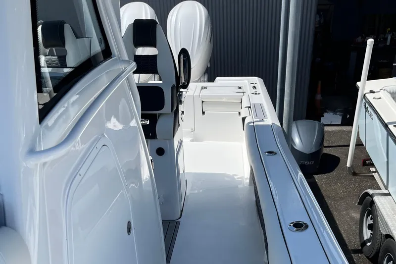 Slide: The Image of 2025 Tidewater 3100 Carolina Bay boat interior with seating and storage compartments. - 16