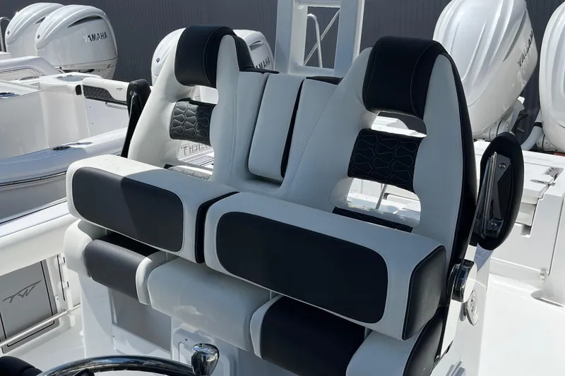 Slide: The Image of 2025 Tidewater 3100 Carolina Bay boat with dual black and white cushioned seats. - 17