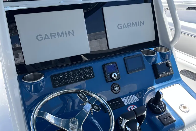 Slide: The Image of Control panel of 2025 Tidewater 3100 Carolina Bay boat with dual Garmin screens. - 18