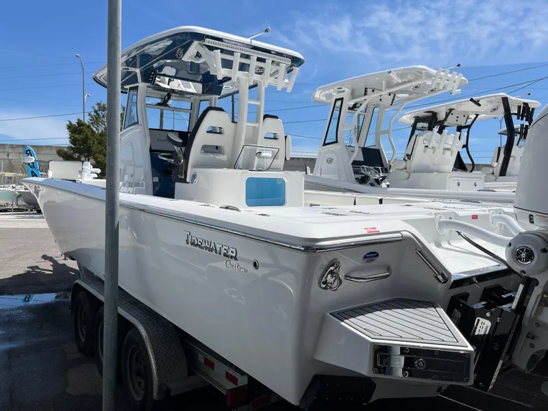 Slide: The Image of 2025 Tidewater 3100 Carolina Bay boat on trailer in marina. - 2