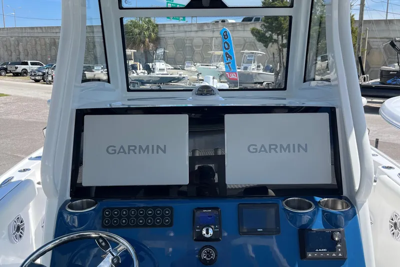 Slide: The Image of 2025 Tidewater 3100 Carolina Bay boat dashboard with dual Garmin displays. - 20