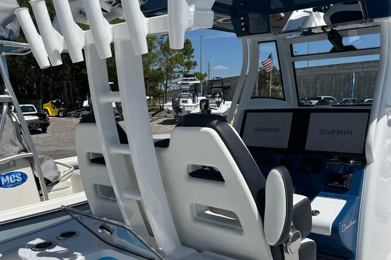 Slide: The Image of 2025 Tidewater 3100 Carolina Bay boat interior with Garmin navigation screens. - 21