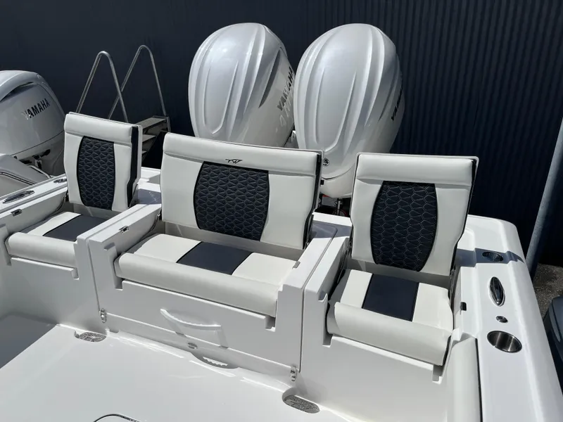 Slide: The Image of 2025 Tidewater 3100 Carolina Bay boat with Yamaha engines and cushioned seating. - 7
